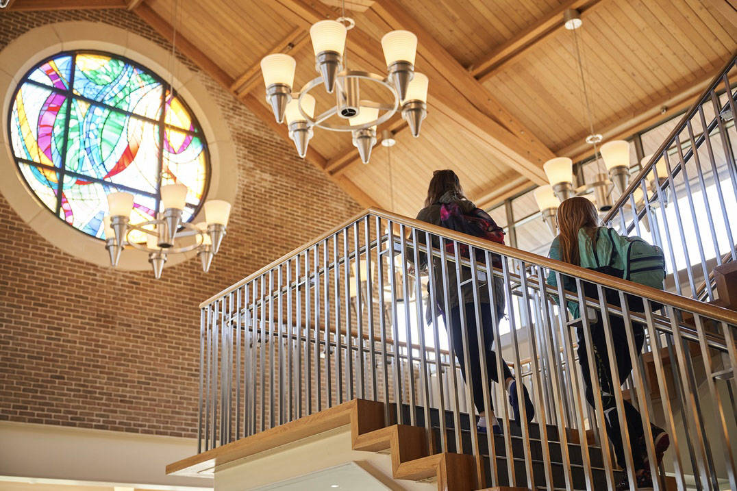 Students ascend the staircase in the Pilla Atrium.