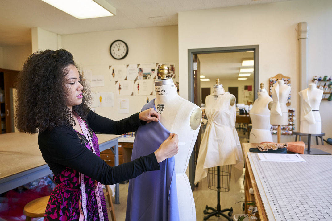 A fashion design student busy at work.