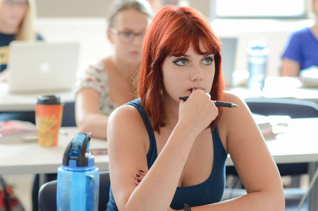 Student listens intently to professor during class