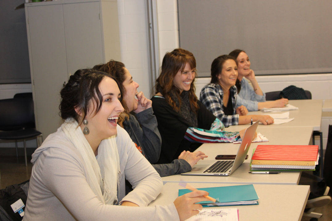 Five students laugh while in class