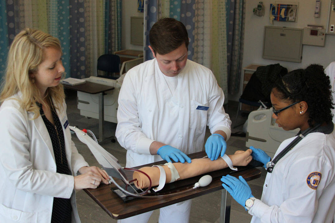 BSN program student identifies vein to draw blood