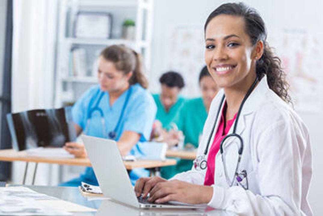 Online graduate nursing student on laptop