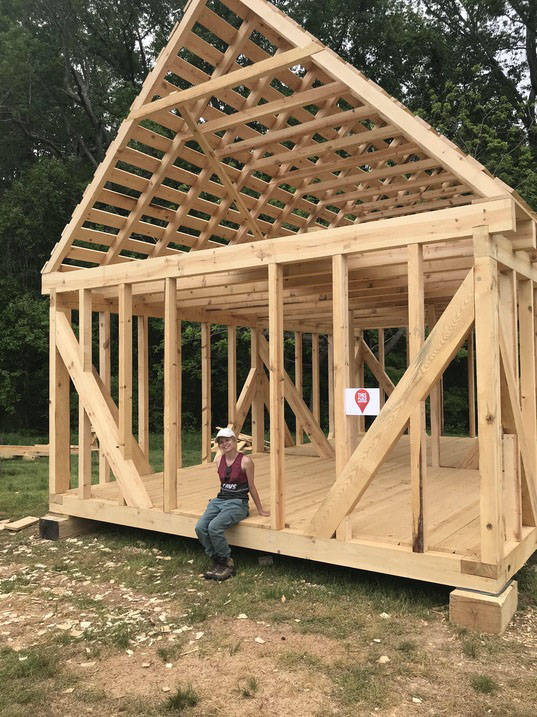 Historic preservation degree student posing with new building frame