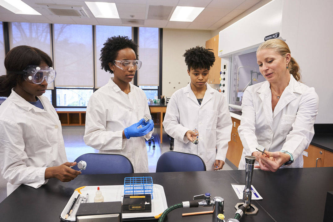 Students and professor discuss experiment