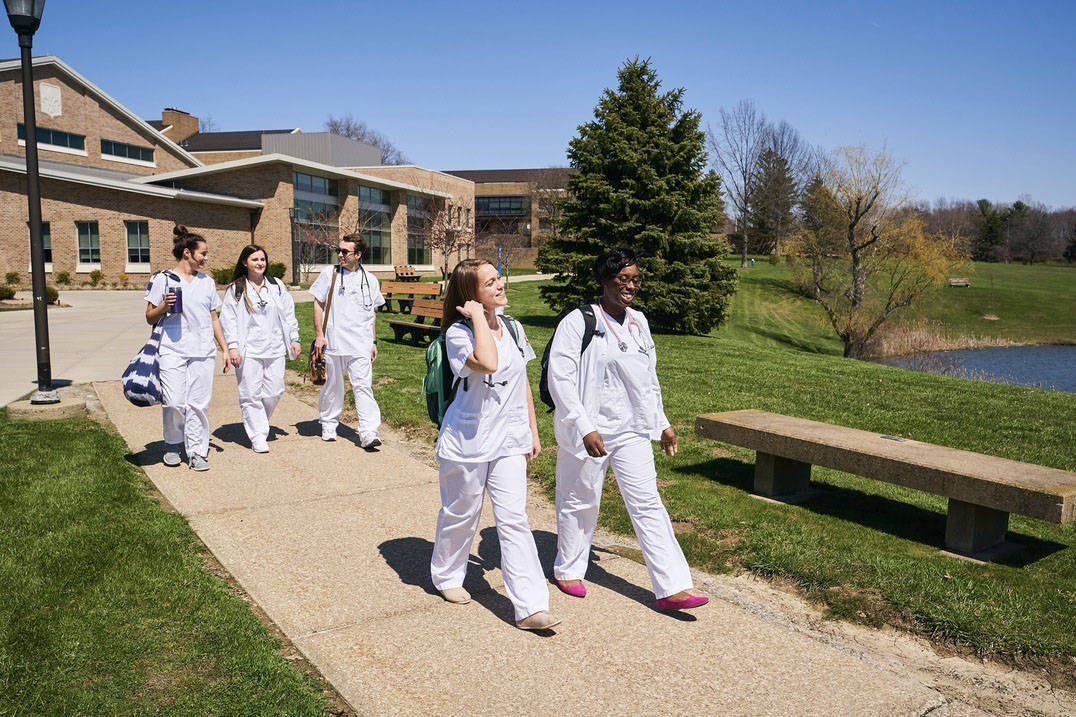 Nursing students walk across campus together.