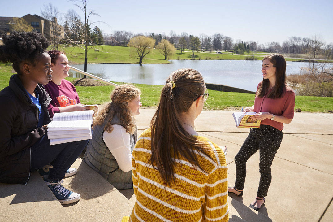 English students enjoy class outside on warm day